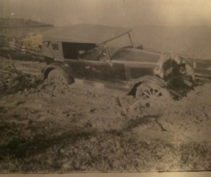 Caption on back reads  In front of Fowles home. An Essex bogged on Ferndale Road. May 1925